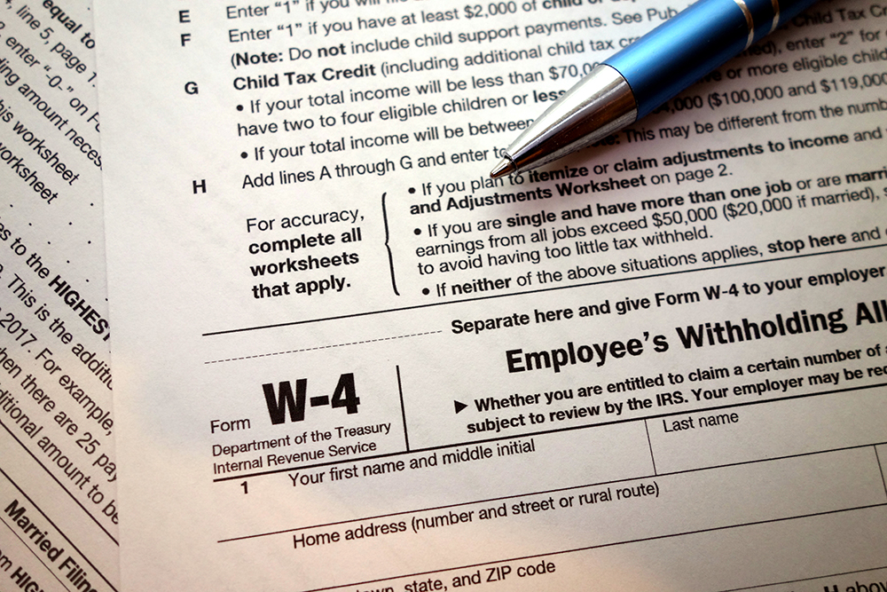 W-4 form and a pen. Tax season