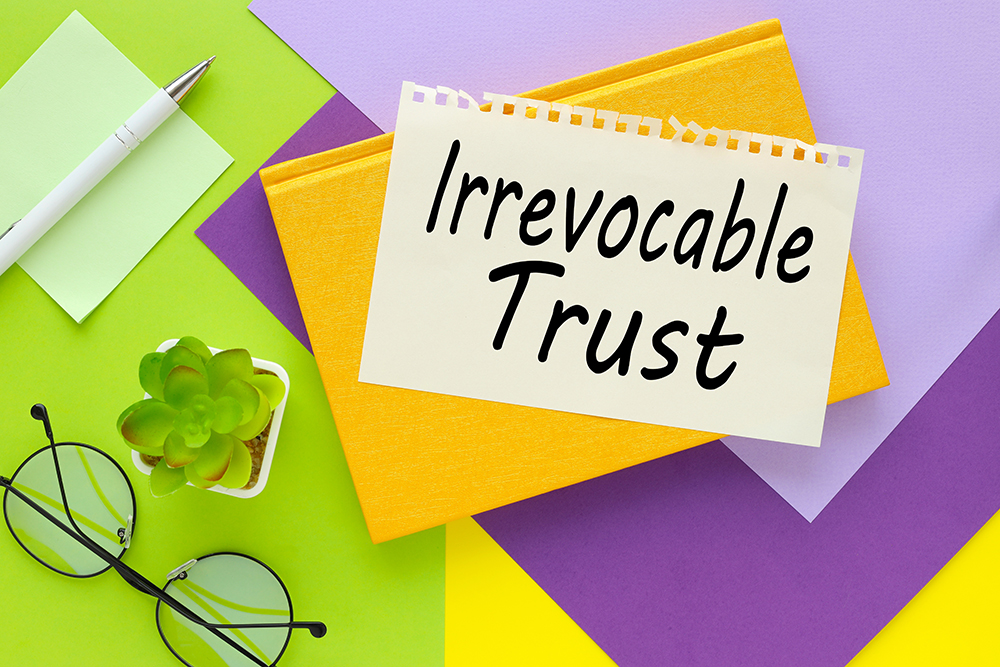 Irrevocable trustbright background. text on paper near glasses and potted plants