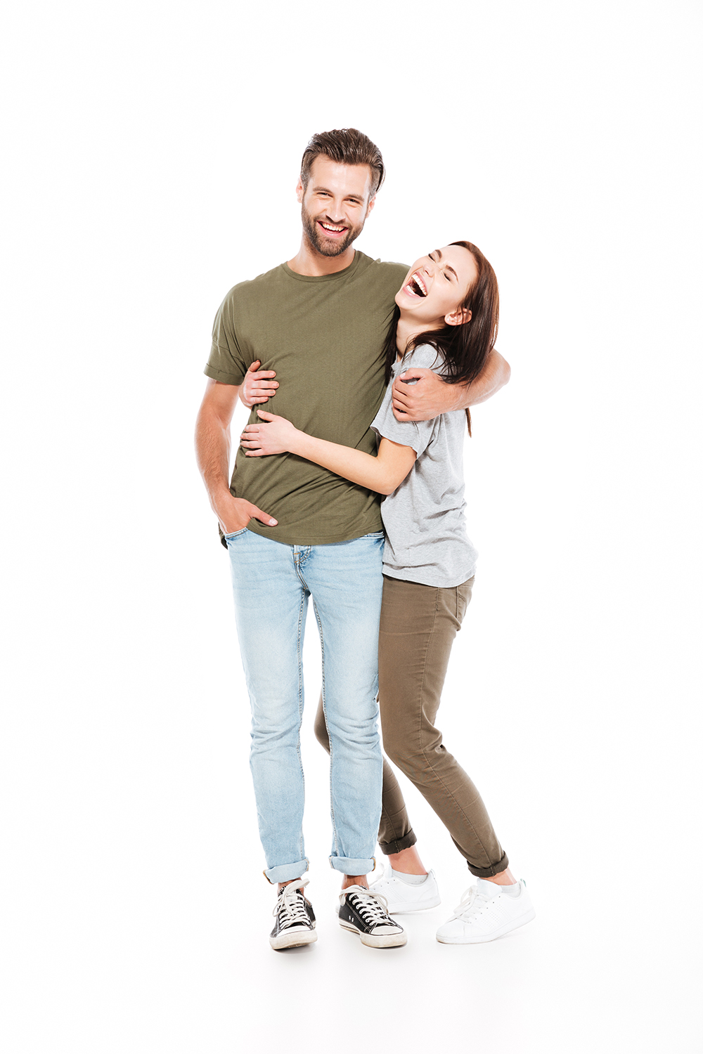 Picture of happy young loving couple standing isolated over white background. Looking at camera.