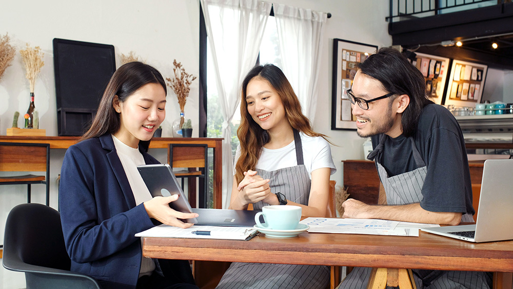 Young asian business woman discussing about financial planning with small business owner at cafe coffee shop, Business meeting corporate partnership, financal loan for start up business