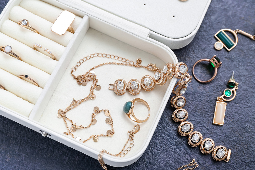 Organizer with stylish jewelry on grunge dark background