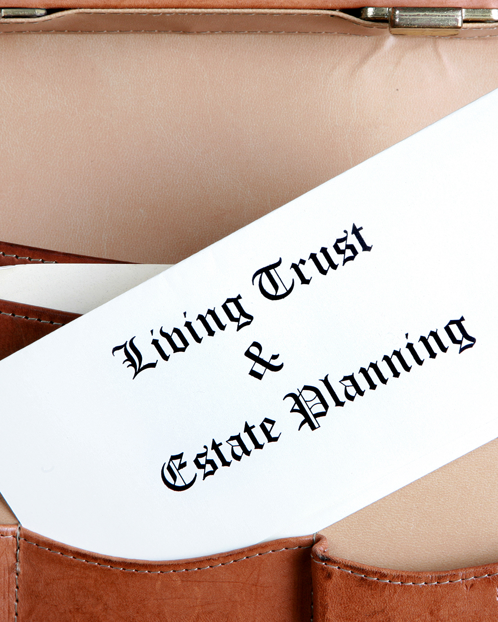 Estate planning documents in a leather briefcase - vertical