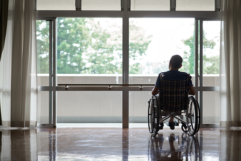 Elderly people in wheelchairs in long-term care facilities