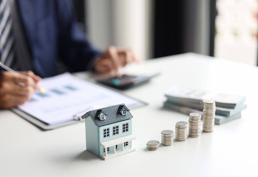 Investing in Real Estate, Real estate agent or investor calculating, planning, analyzing financial data for property investment. Themes of saving, investing, financial aspects of purchasing a home.