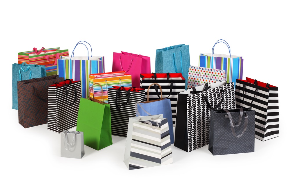 Photo of a large group of colourful shopping bags. Clipping path included. Shadows visible.