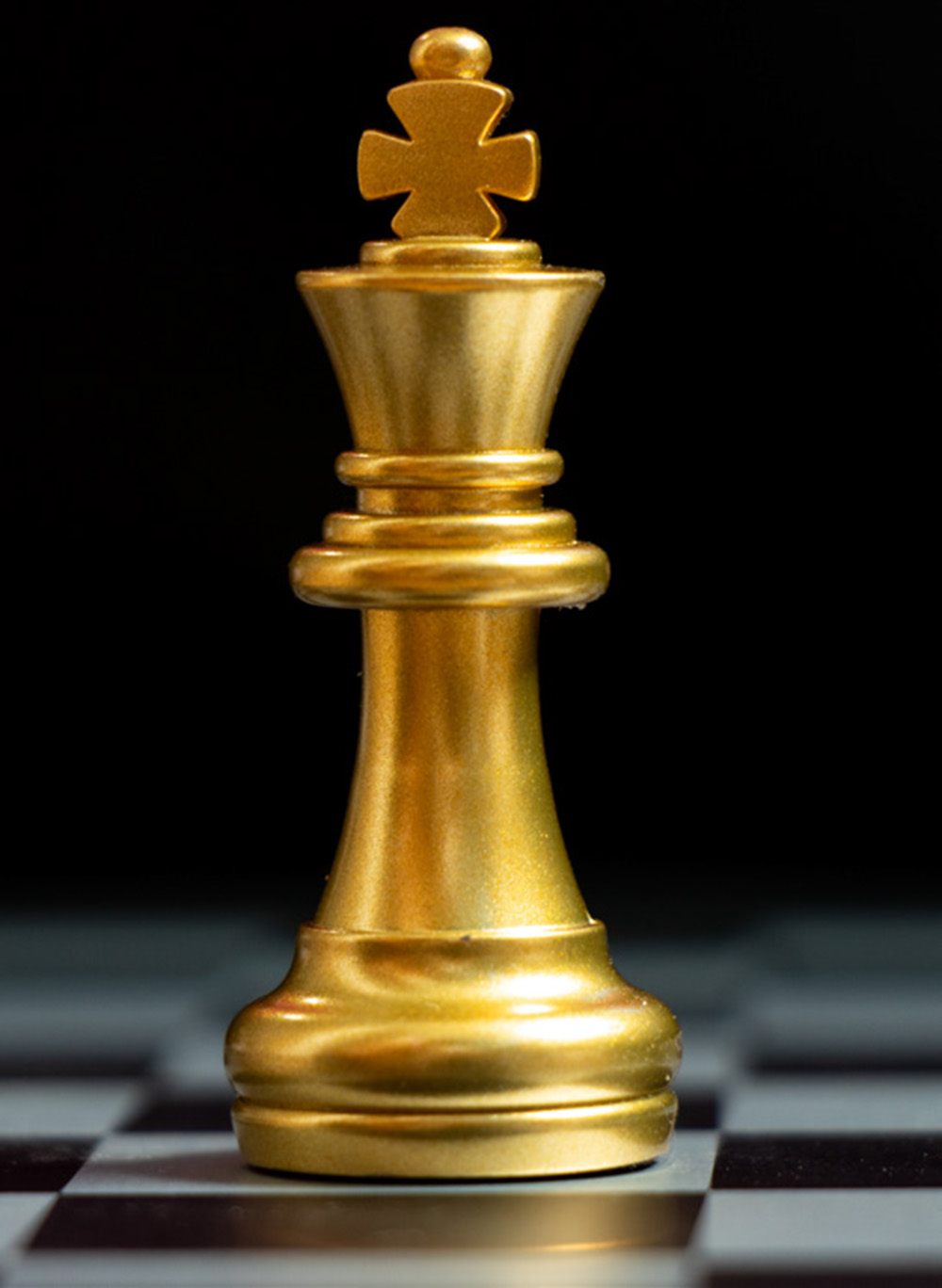 Gold king chess piece stand on black background (Concept for leadership, unique)