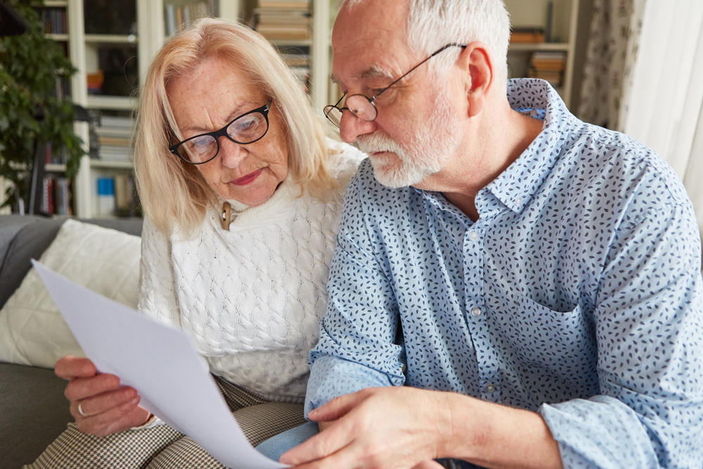 Couple of seniors reading a contract or health care proxy or living will