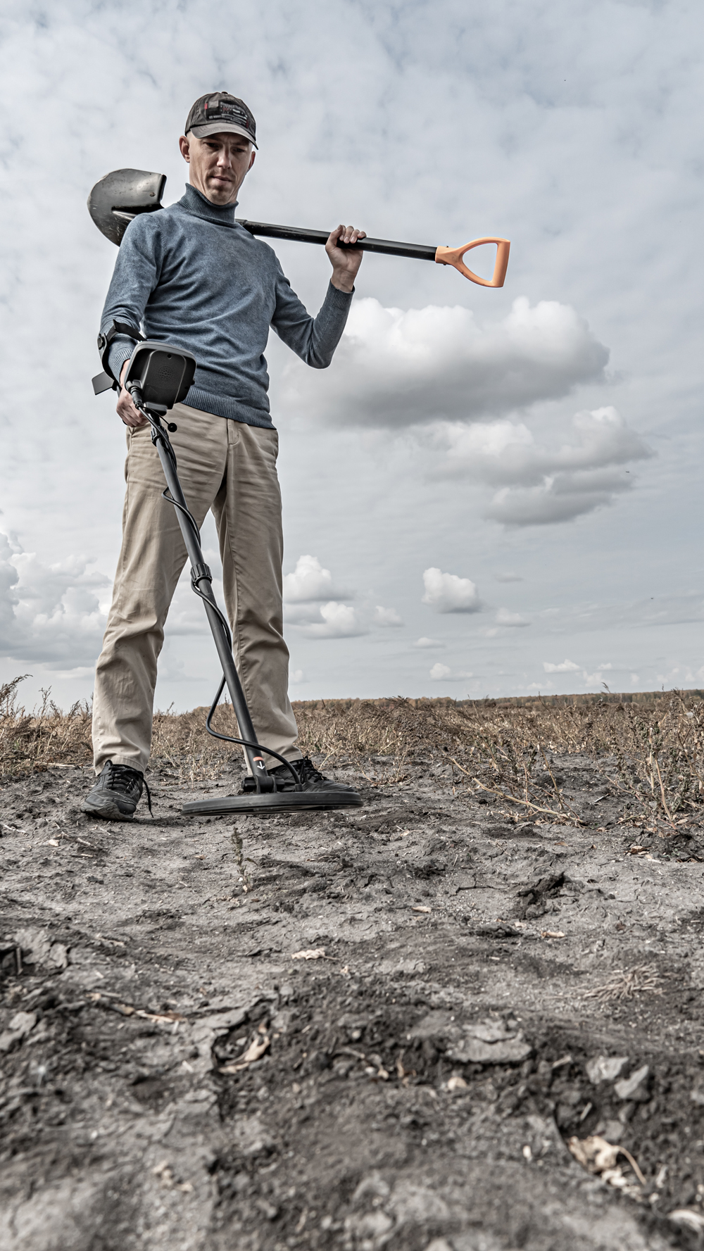 Archaeological and treasure hunting with a metal detector.Hunting for relics in the ground.Search for antiques.Soil research on gold nuggets.A man with a metal detector and a shovel.Finding  research