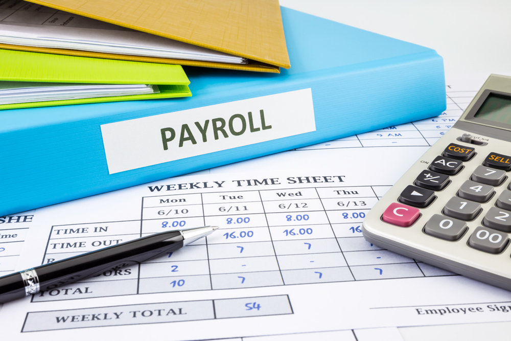 PAYROLL word on blue binder place on weekly time sheet and payroll summary report, human resources concept