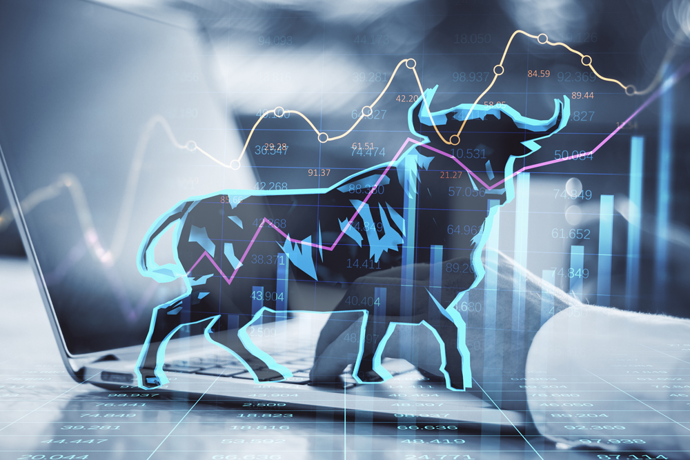 Concept of bullish market. Close up of businessman hands using notebook keyboard with glowing bull hologram over forex chart on blurry background. Trade and invest concept. Double exposure