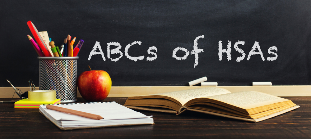 Teachers desk with writing materials, a book and an apple, a blank for text or a background for a school theme. Copy space.