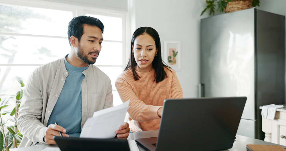 Happy couple, paperwork and technology for savings, paying bills or estate planning. Married people, conversation and budget for insurance policy, investing or tax returns in apartment or family home