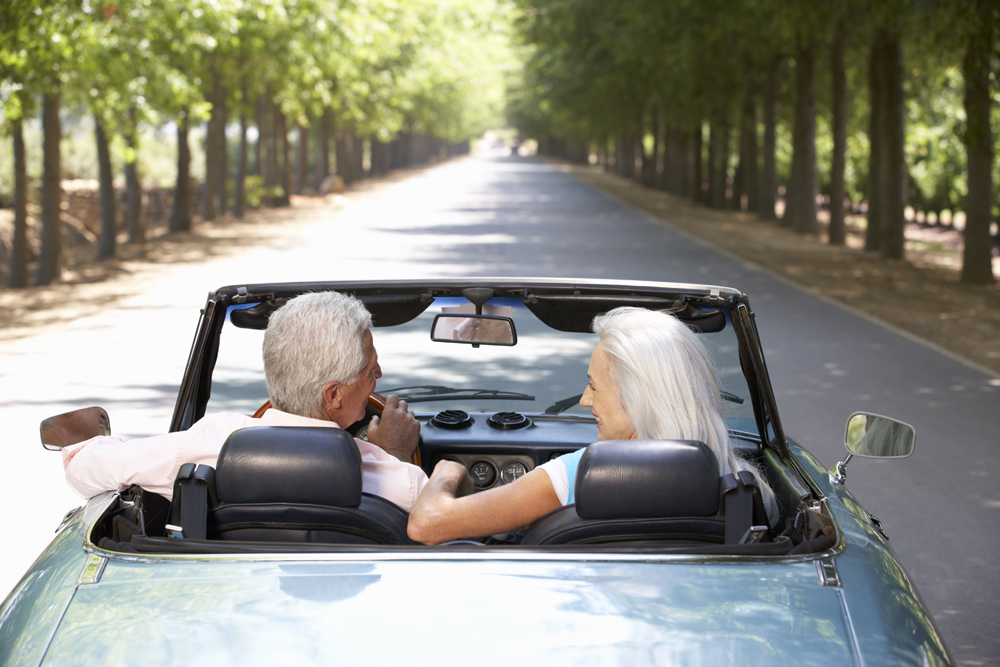 Senior couple in sports car