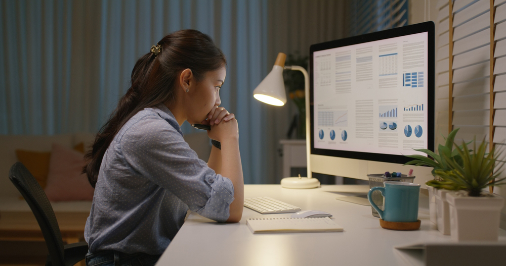 Asia people young woman study hard overnight brownout bored remote learn online read data tired sitting head in hands at home office desk workplace think worry in job tough stress workforce issue.