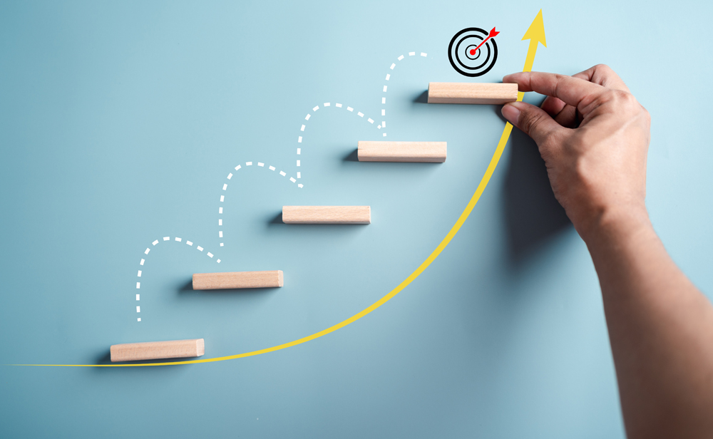 Business growth success achievement concept, hand arranging wooden block stacking as step stair or ladder for planning development leadership and customer target group concept.