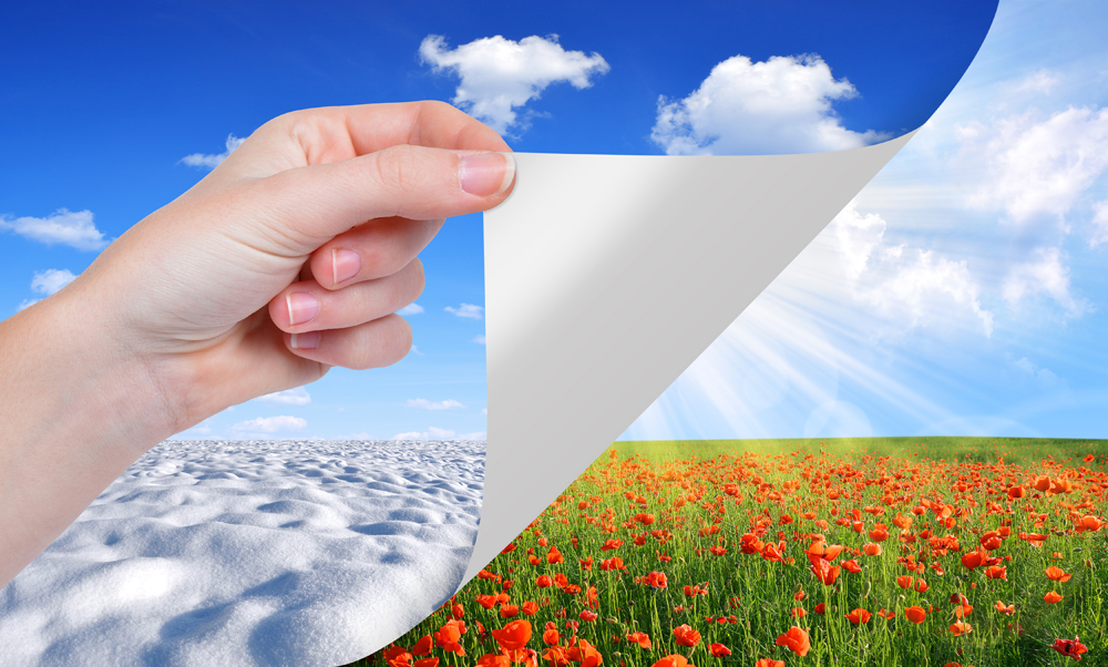 Hand turns a sheet of paper. Seasonal concept.