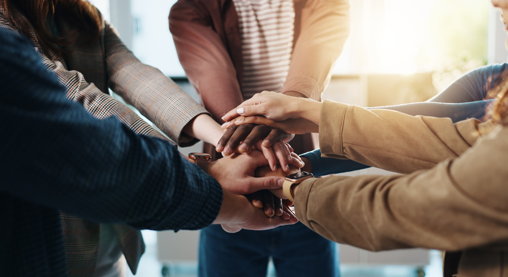 Business, people and hand stack in office for team building, solidarity and trust with motivation. Staff, scrum and hands together in circle for collaboration, employees unity and huddle with synergy