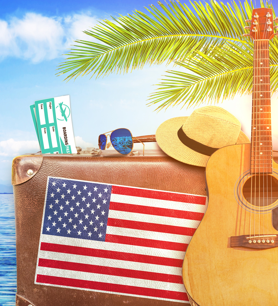 Concept of summer traveling with old suitcase and US town sign