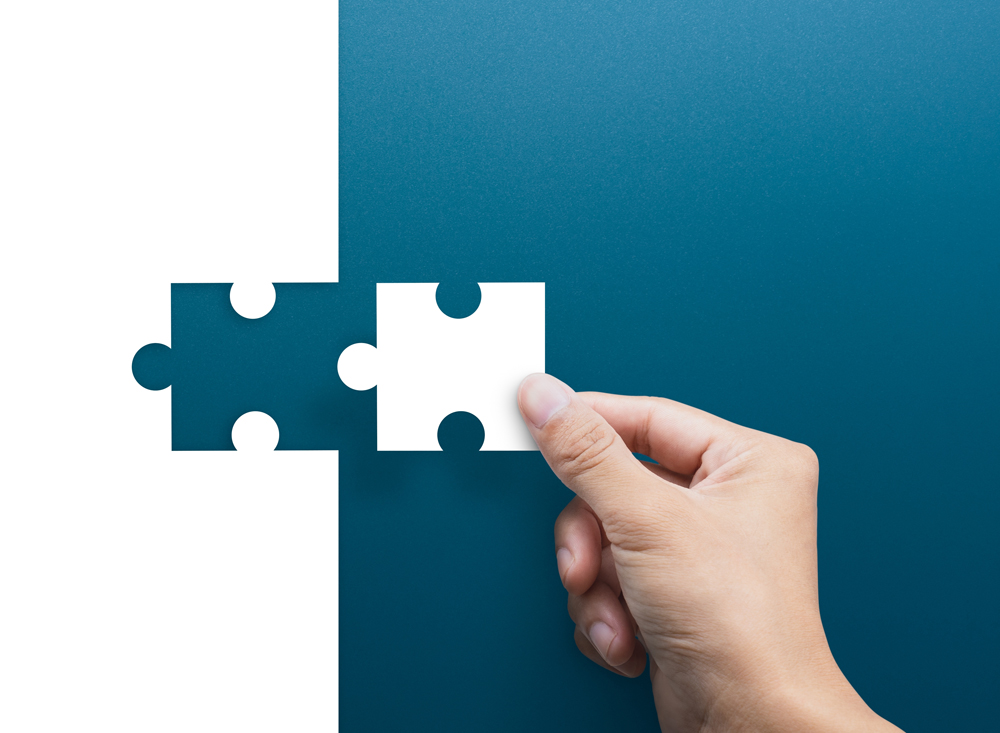 Joint venture, partnership, Mergers and acquisition concept, businessman hand connecting puzzle pieces, copy space