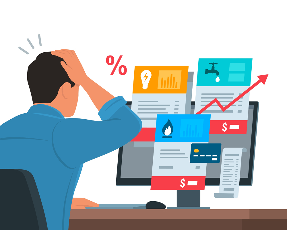 Worried man sitting at desk and checking expensive utility bills on his computer, payments and budget concept