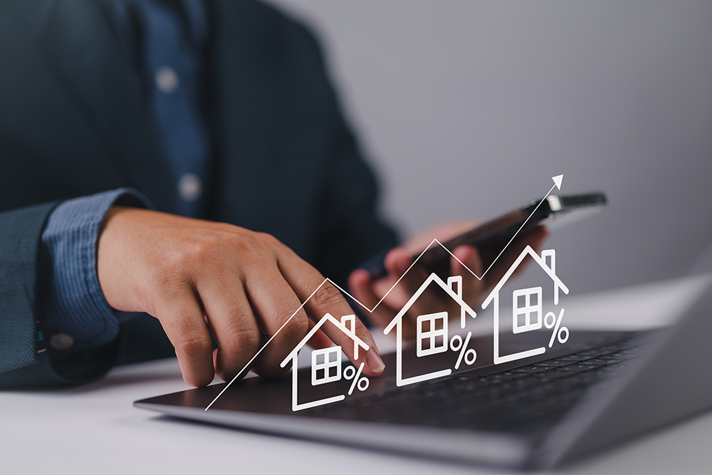 Real estate investment concept. Person using laptop with house icon and growth graph. Analyzing mortgage loan home and insurance real property mortgage. interest rate, Investment planning.